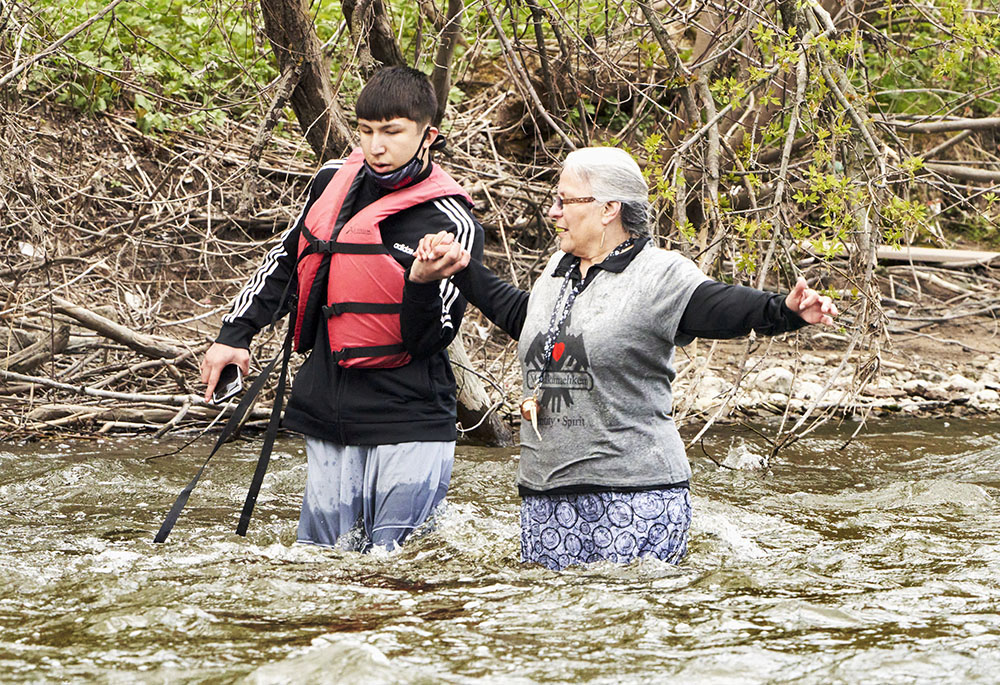 Jaden helps Dawn to the shore