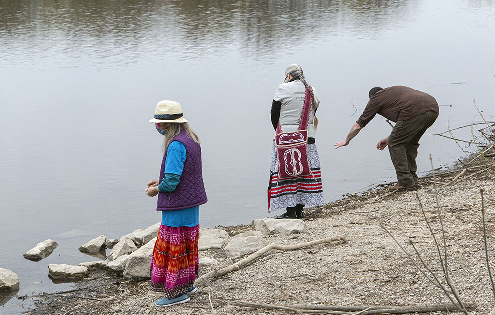 Offering tobacco to the river before setting out.