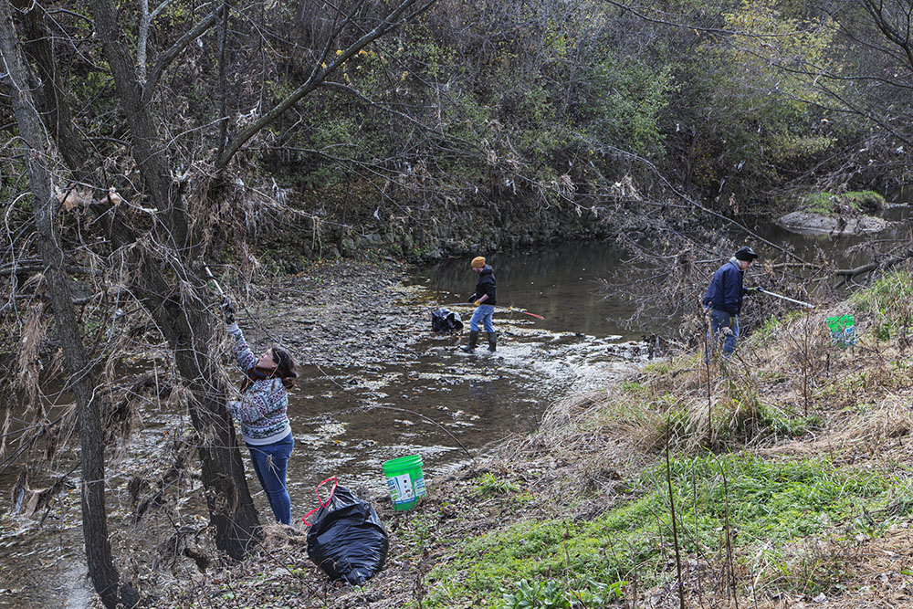 Volunteers cleaning up Lincoln Creek in preparation for the trail opening.