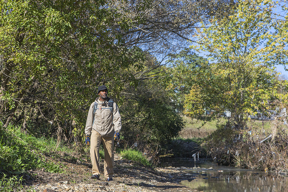 Nearby Nature MKE Program Director Steven Hunter walks along Lincoln Creek in the Greenway.