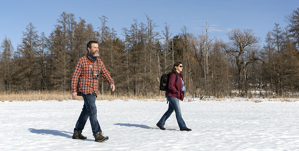 The artists walk on the frozen lake at Zinn Preserve.