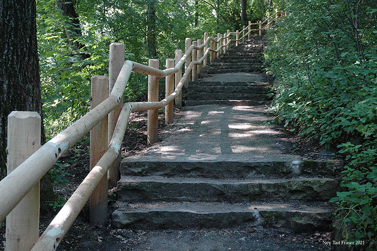 Refurbished stairway with new white cedar rails.