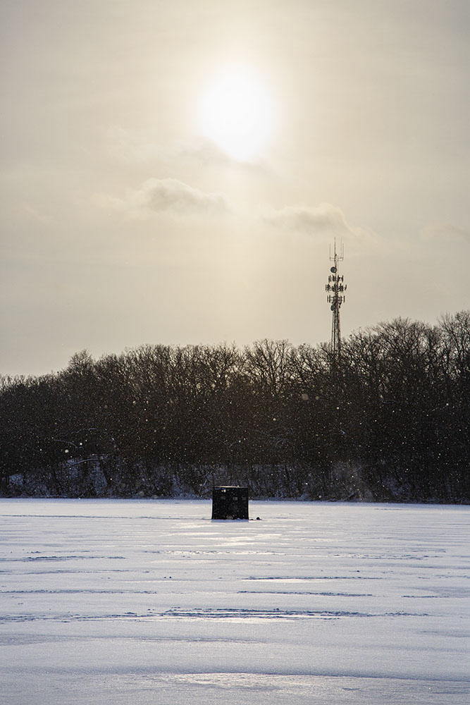 An ice fishing hut glows under the winter sun at Nashotah Park.