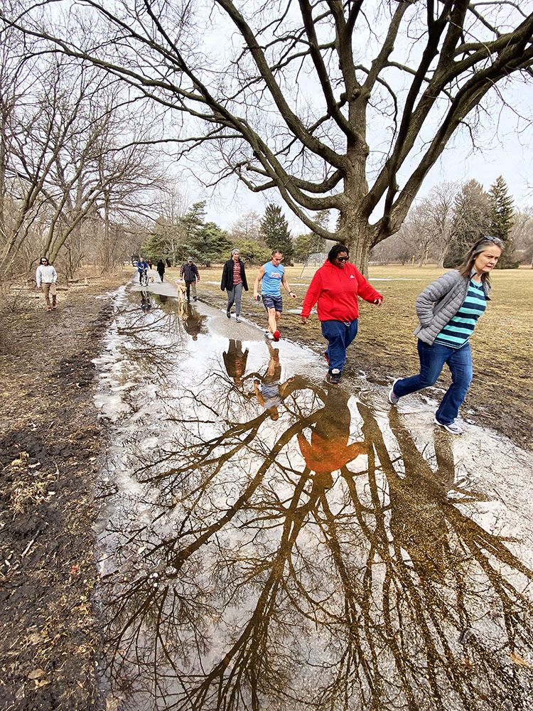 Crowds negotiate a puddle on the Oak Leaf Trail in Hoyt Park.