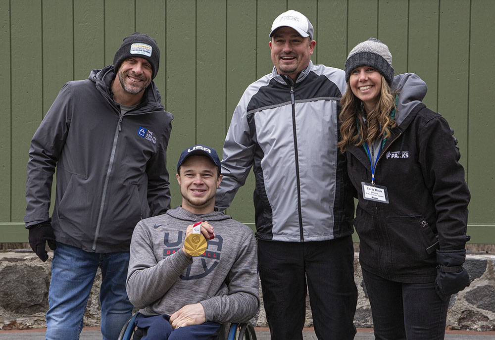 Left to right: Damian Buchman, Executive Director of The Ability Center, John Boie, with his gold medal, Guy Smith, Executive Director of Milwa