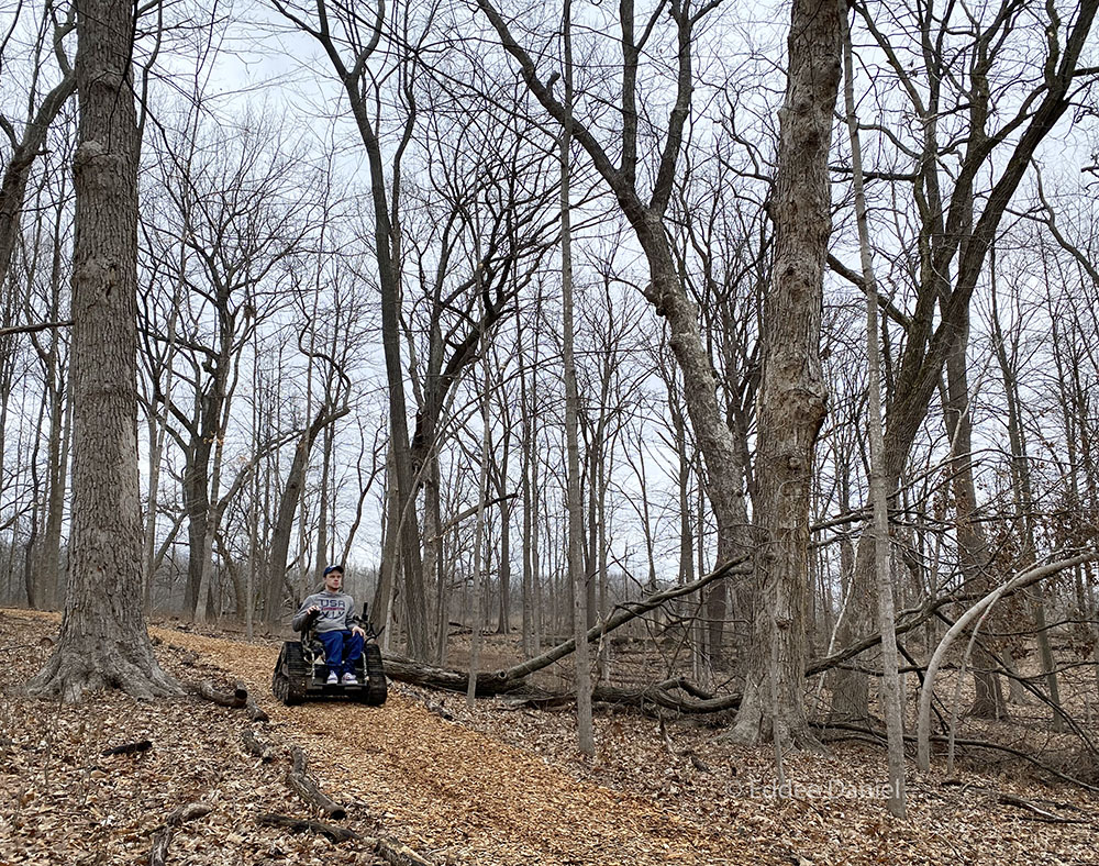 Paralympic gold-medalist John Boie on Woodland Trail with his personal motorized all-terrain wheelchair.