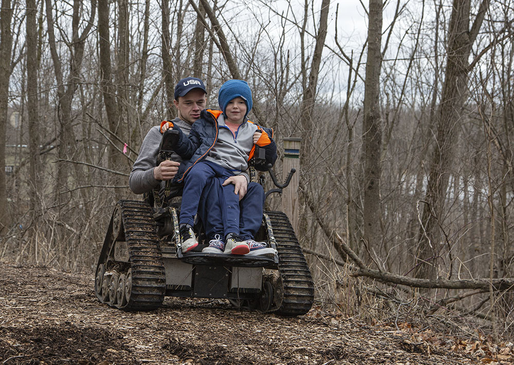 John Boie gives a young visitor a chance to steer his wheelchair.