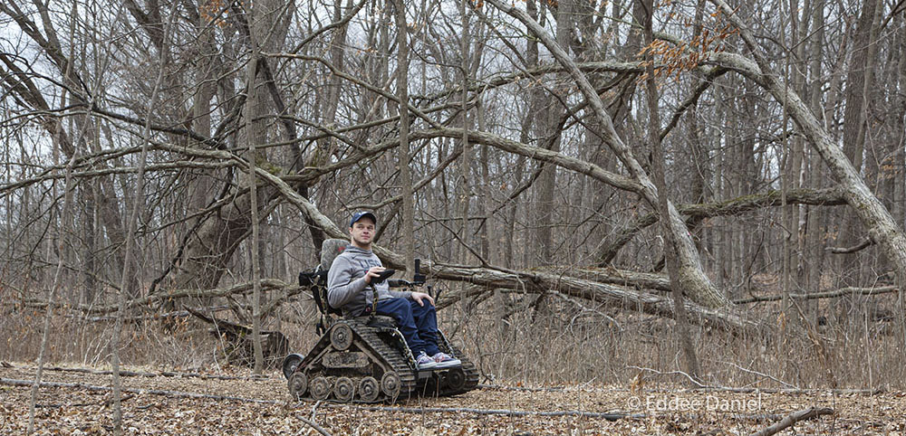 Paralympic gold medalist John Boie on his all-terrain wheelchair on the Woodland Trail at Wehr Nature Center