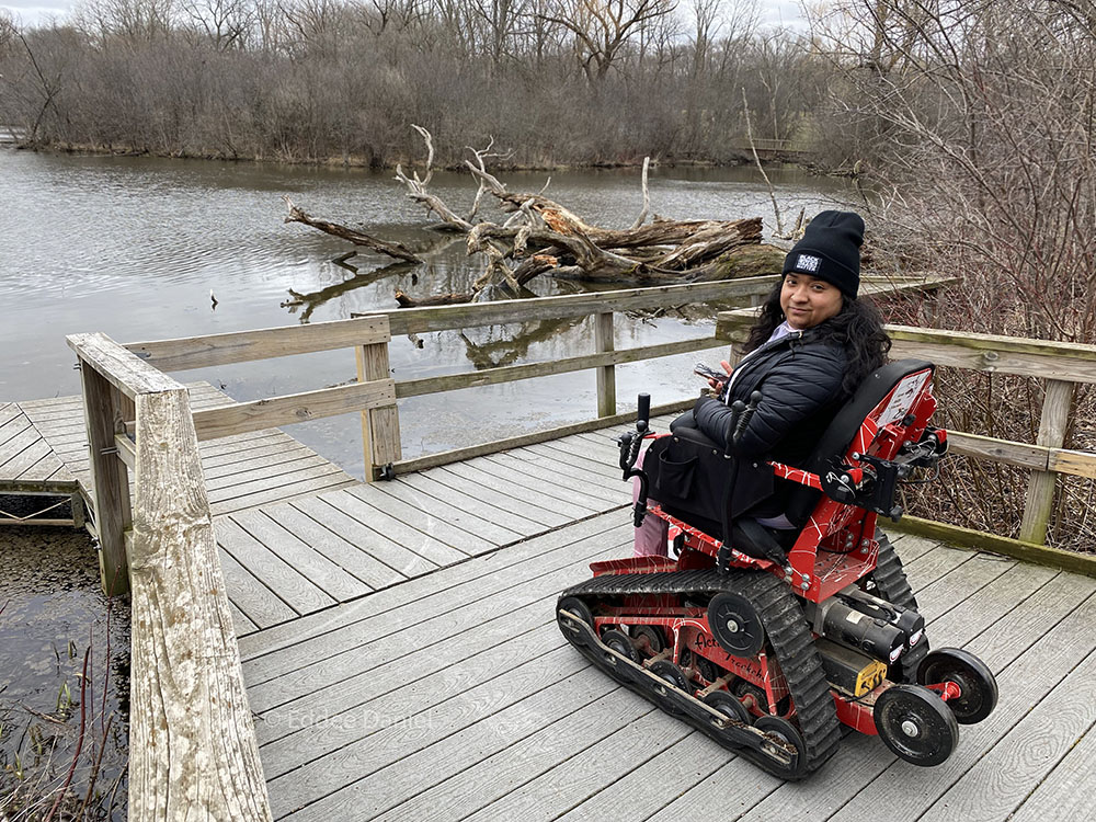 Alondra, a first-time visitor to Wehr, on one of the all-terrain wheelchairs provided by Access Ability WI. 