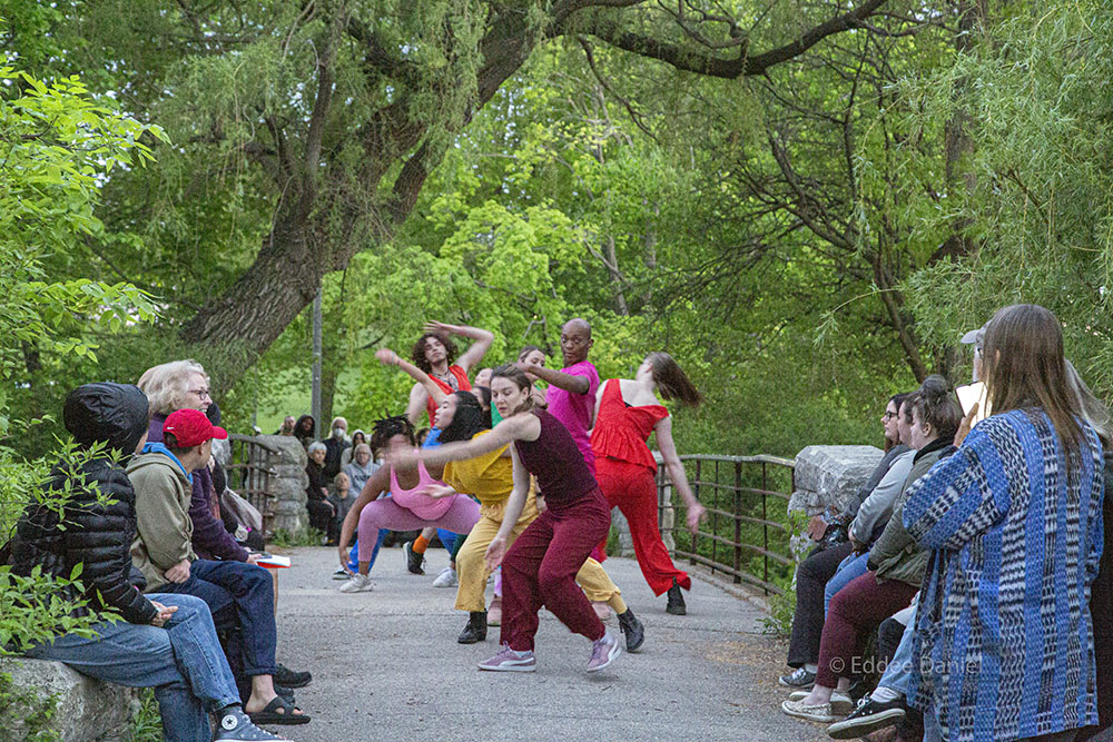 dancers and audience on stone bridge