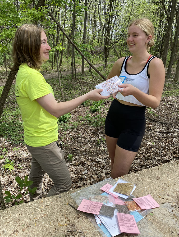 Hallie gave out individual packets of seeds to members of the seeding team.