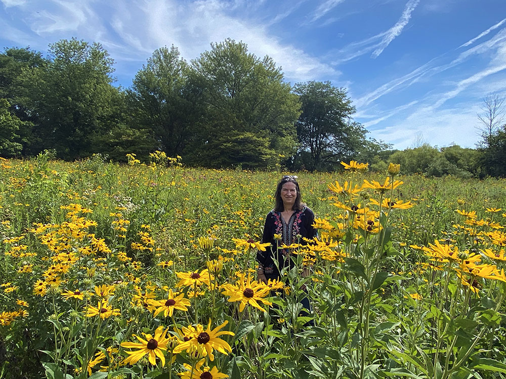 The artist amid wildflowers in a prairie meadow at the preserve.