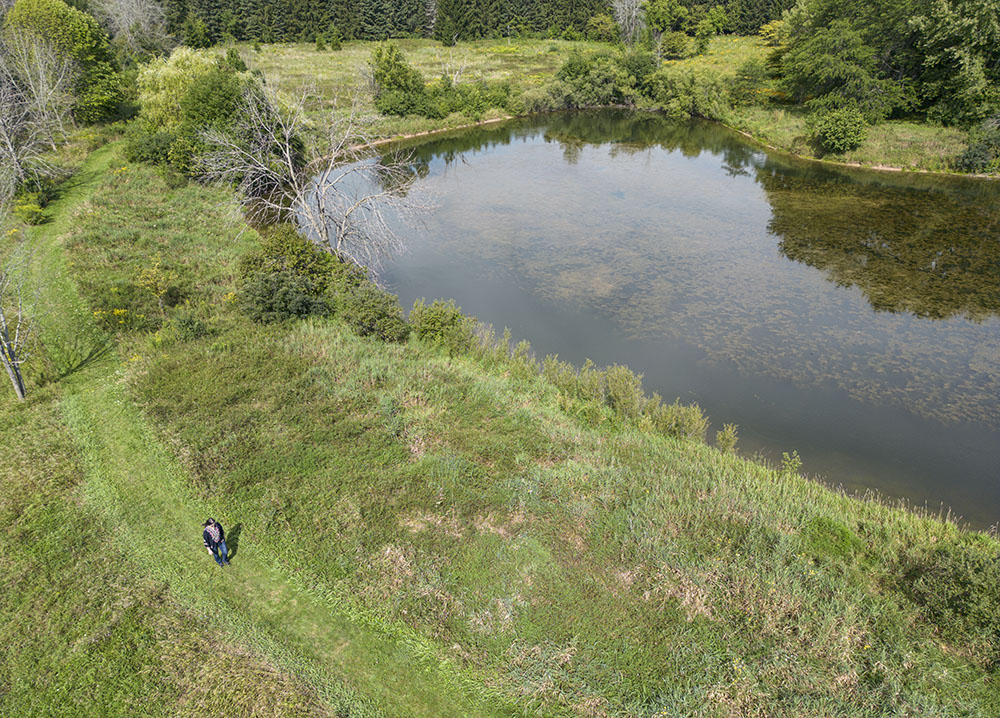 An aerial view of Deb Mortl walking the berm trail around Spirit Lake.