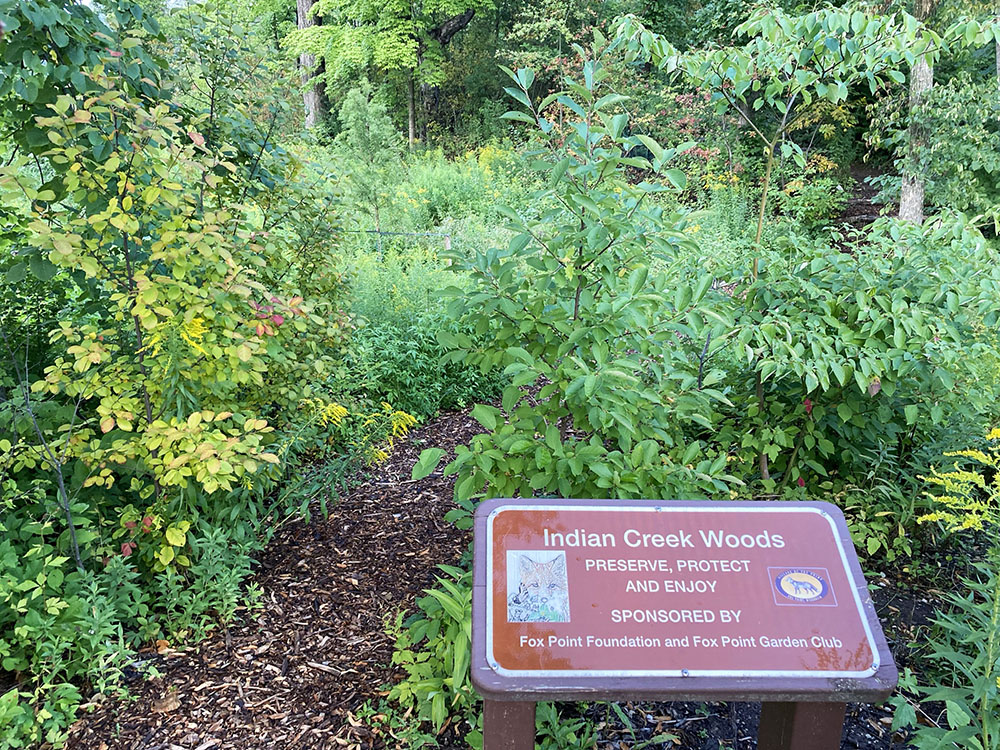 Signage, here on the western edge abutting Mohawk Road, welcomes visitors to the Indian Creek Woods.  