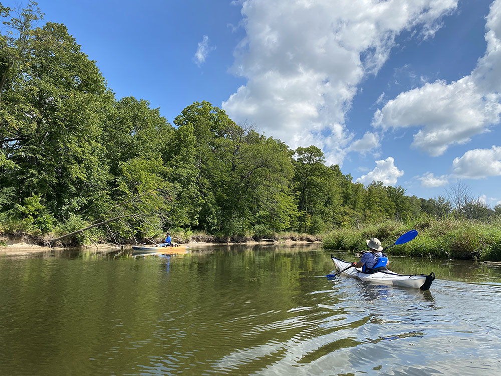 Kayaks passing in peaceful passivity