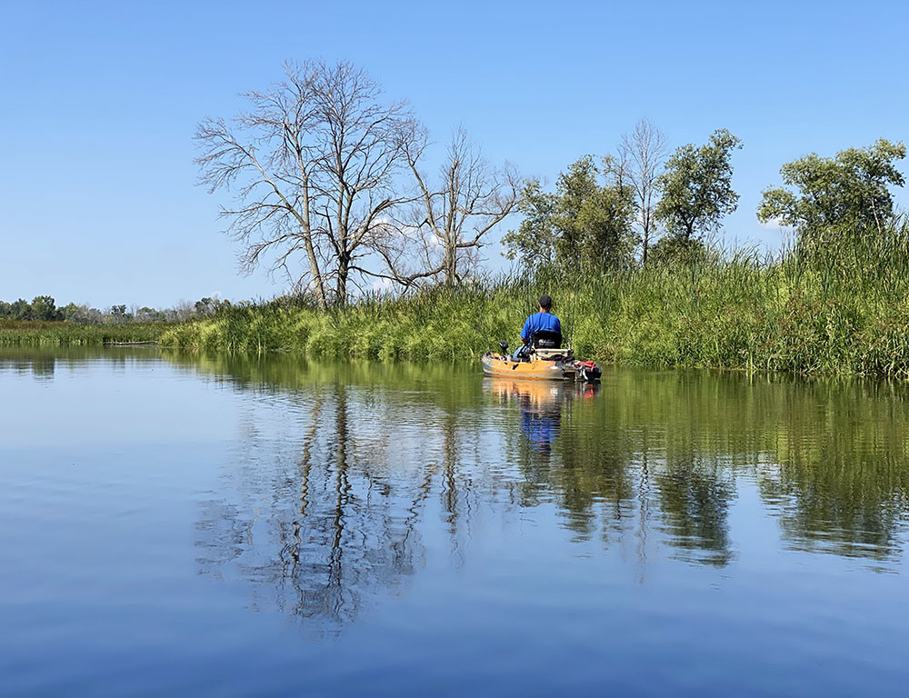 A kayaker fishing peacefully