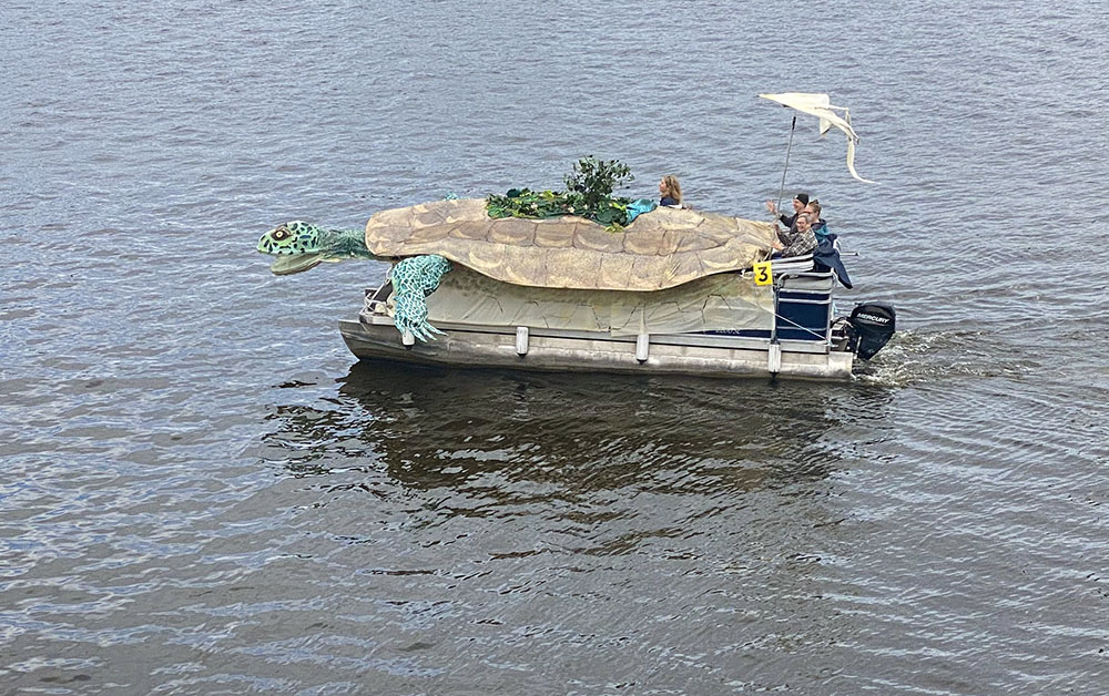 A boat decorated to resemble an enormous turtle. But look closely, there's more: The turtle also is a Native American symbol for planet Earth known as Turtle Island.