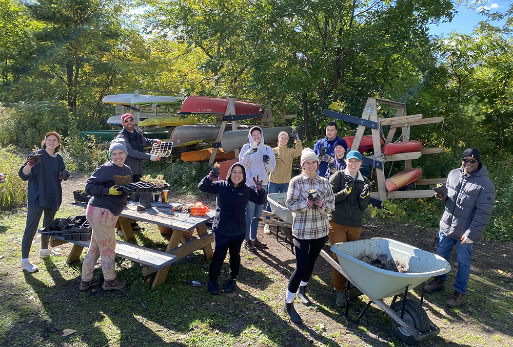 UW-Milwaukee Students and community volunteers re-pot native plants in Turtle Park. CP