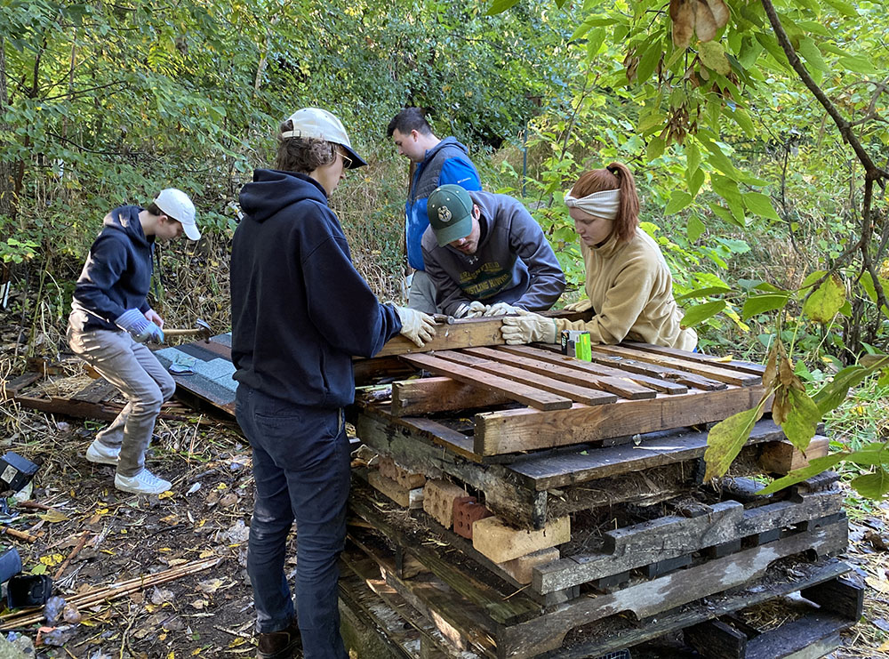 UW-Milwaukee students hard at work on the bug hotel structure and roof.