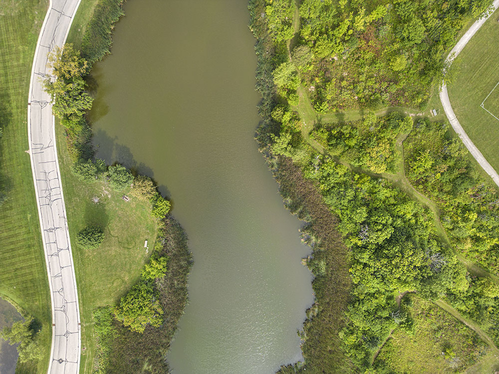 Aerial view of pond and trails.