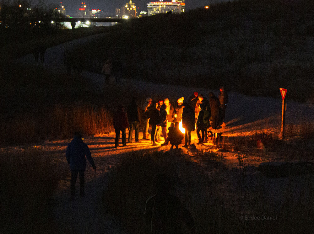 A campfire within sight of downtown Milwaukee during the annual Urban Candlelight Hike in Three Bridges Park.