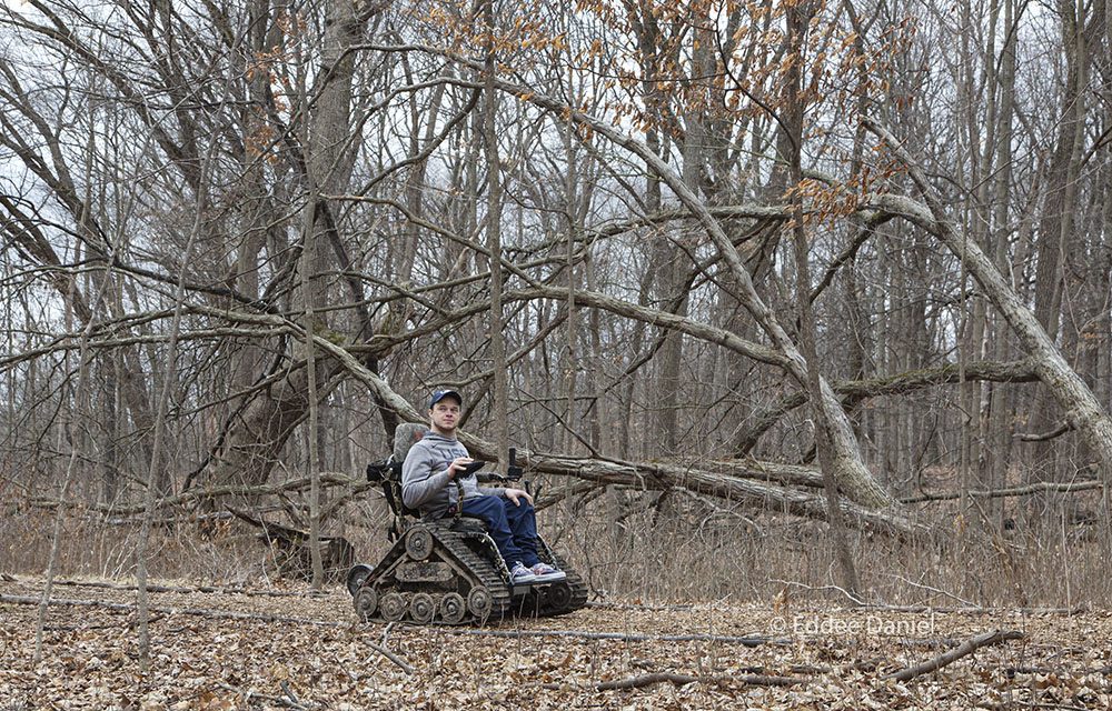 Paralympian gold medalist John Boie on his all-terrain wheelchair on a Wehr Nature Center trail.