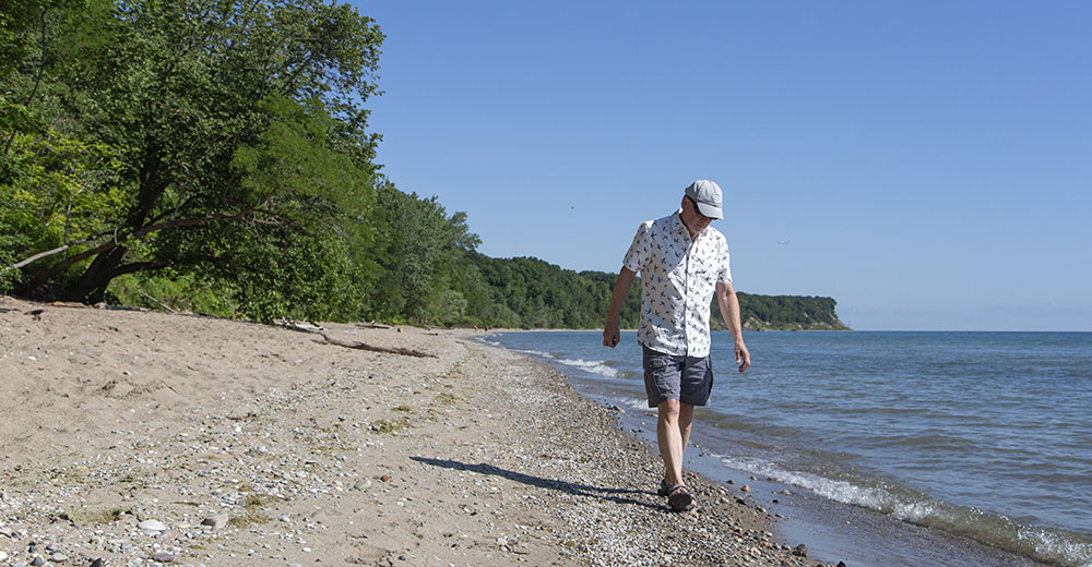 Jim Toth walking on the beach at Grant Park.