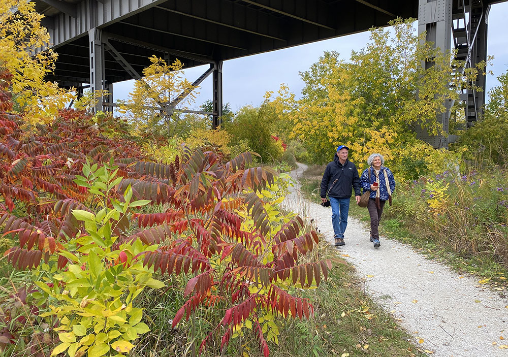 A gravel trail ducks under the 35th Street viaduct.