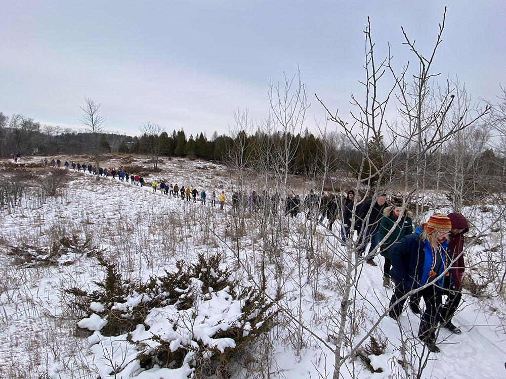 The line of hikers sets out from the UWM Field Station, heading for the bog.