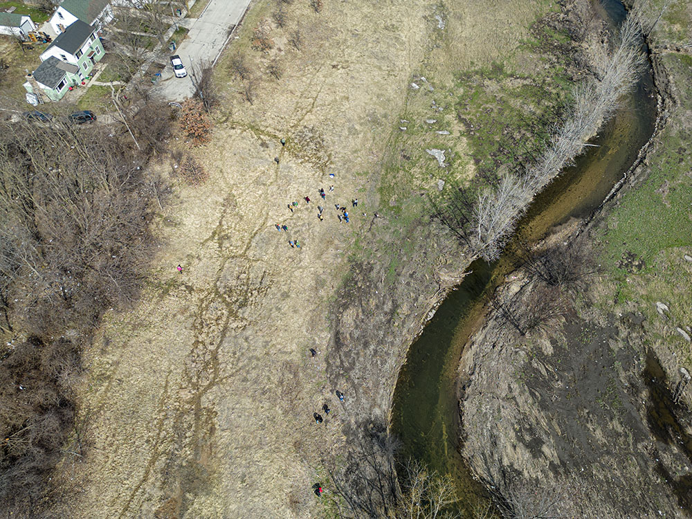 Aerial view of the group spread out on the prairie restoration site. 