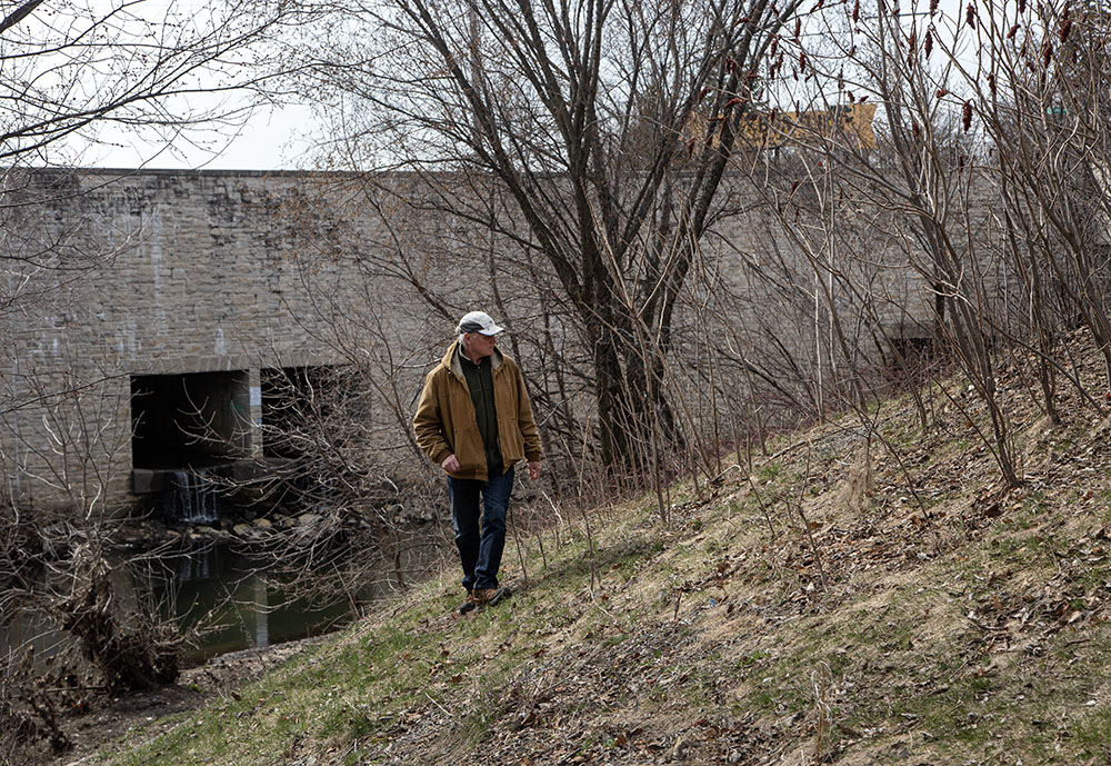 Scientist Gary Casper exploring near the 35th Street bridge over Lincoln Creek.