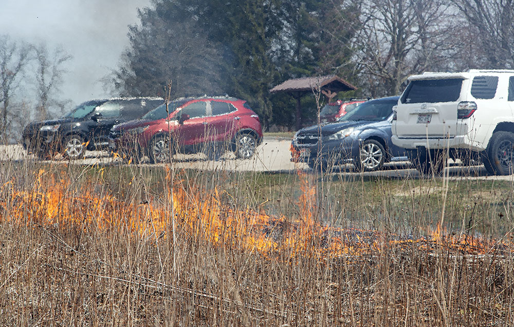 The burn in proximity to a parking lot full of cars