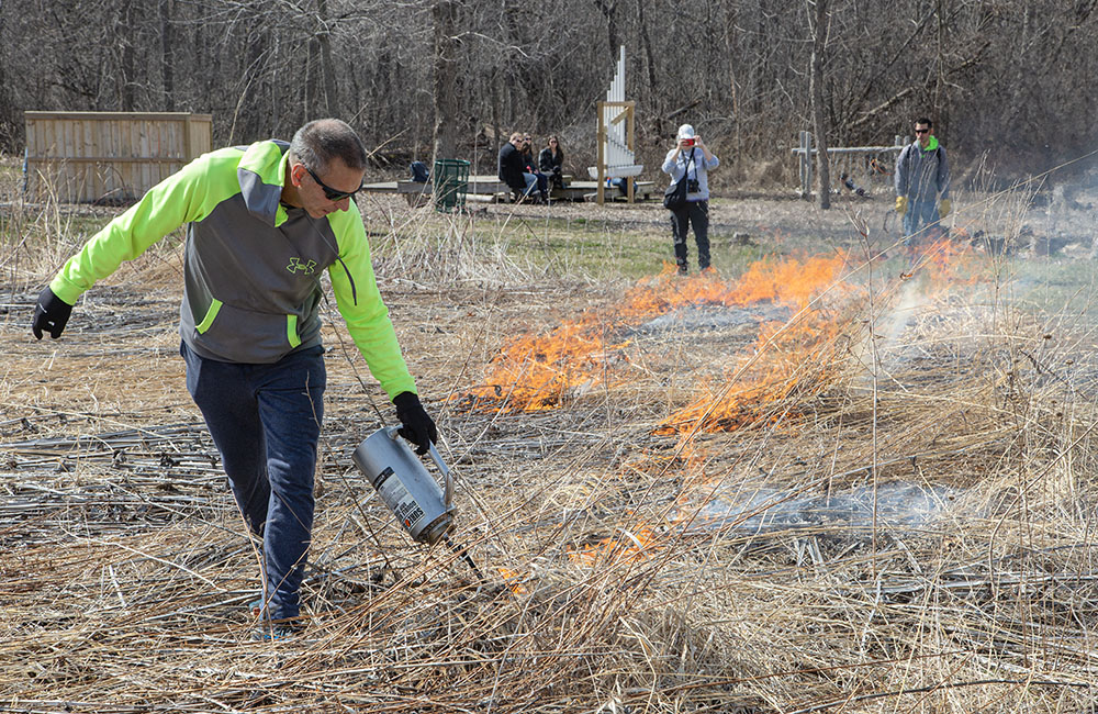 Spectators document the burn with cell phones.