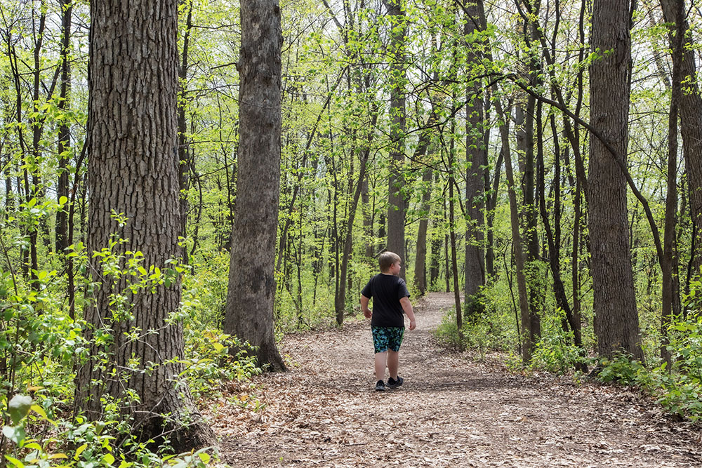 A boy on the mulched path in Biwer Park. 