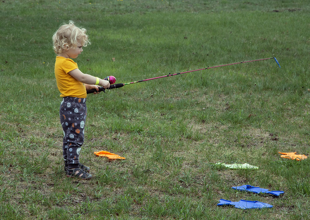 Other children were learning to fish on dry land.