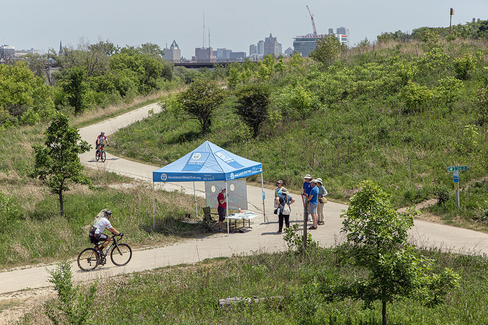 A booth for the Friends of the Hank Aaron State Trail on the trail, which runs through Three Bridges Park.