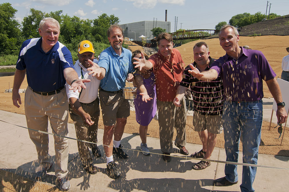 A variety of dignitaries--including Tom Barret, then Mayor of Milwaukee; John Dargle, then Milwaukee County Parks director; Laura Bray, then Executive Director of Menomonee Valley Partners; and Ken Leinbach, then and current director of the Urban Ecology Center--symbolically sowing the seeds for the new park at the opening ceremonies in 2013.