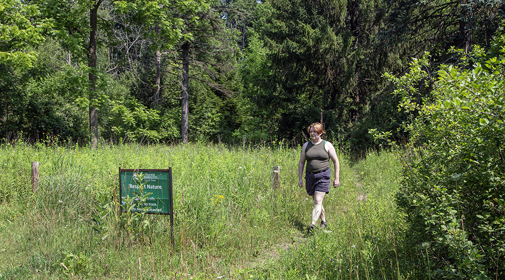 Artist in residence Alecia McBride walking in meadow