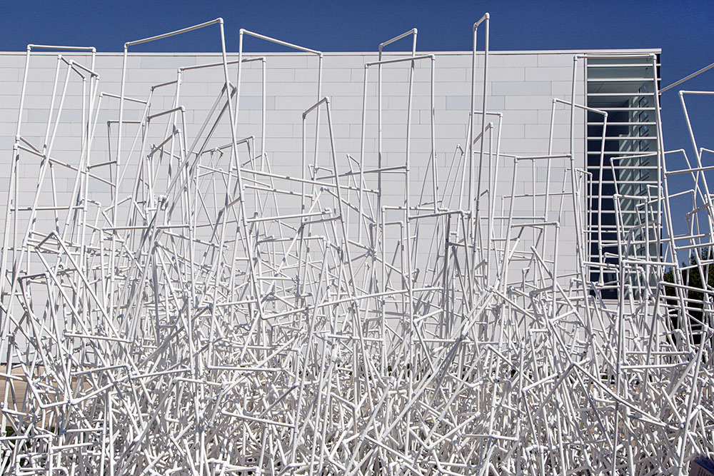 "The Legend of the White Snake" (detail) by Jason Yi. PVC pipes. A site-specific installation that creates a dialogue with the architecture of the Museum of Wisconsin Art (background).