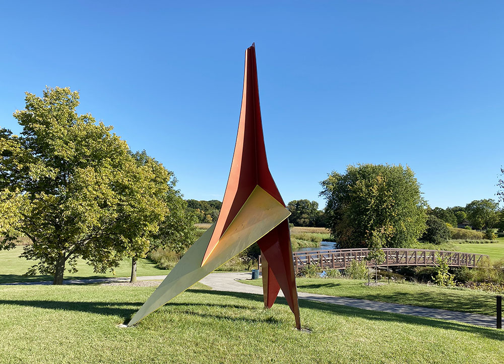 "Paradisidae" by Narendra Patel. Painted steel. This 17-ft. tall sculpture seems to soar like a large prehistoric bird lifting itself to flight.