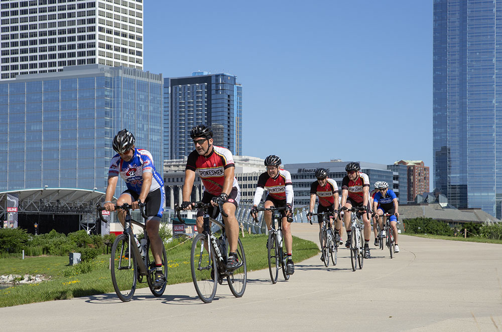 Crouching down for a low viewpoint makes these cyclists appear larger against the backdrop of the buildings.