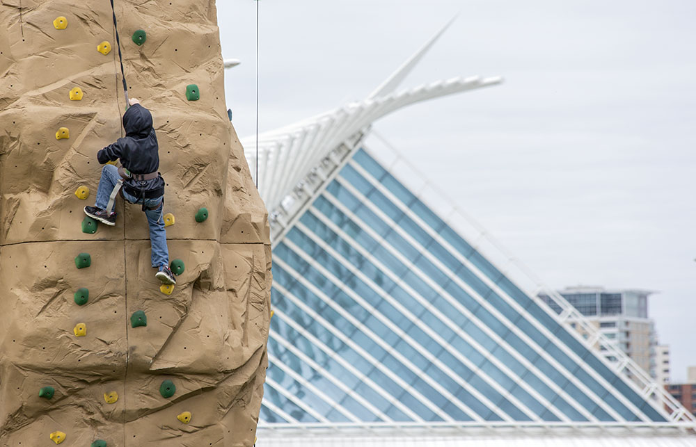 A telephoto lens and careful positioning relative to the foreground subject and the background lends a sense of mystery to this scene from an event at the park.