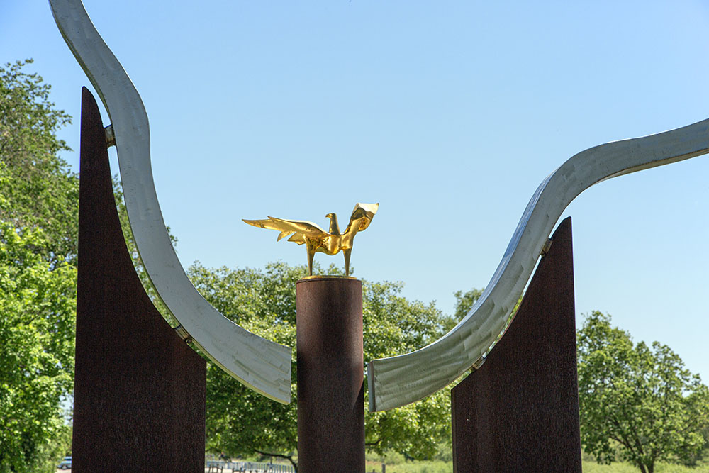 "West Bend Resolve" (detail, see also featured photo at top) by O.V. Shaffer (Beloit, WI). Mixed media. This sculpture imitates the westerly bend in the Milwaukee River that give the city its name. Perched in the center is a gold-plated, cast-bronze eagle.