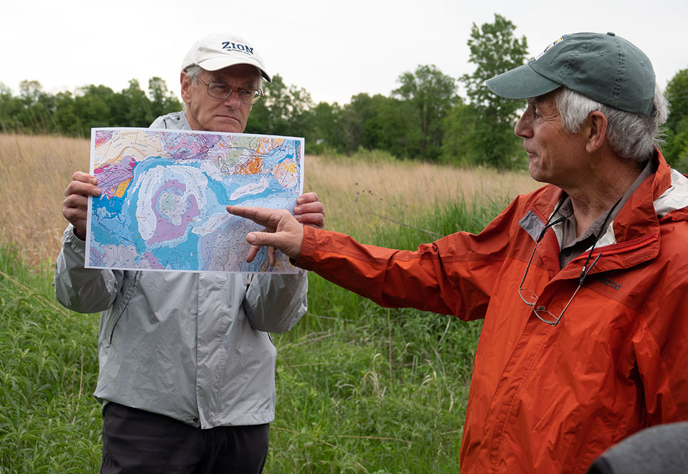 Bradbury (right) with a map showing the Niagara Escarpment. Photo by Andy Holman.