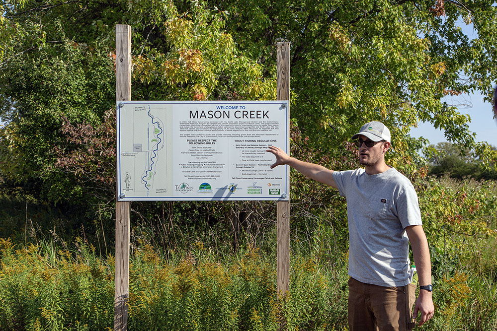 Paul Meuer, Tall Pines Conservancy Land Protection Manager and the newly installed Mason Creek sign.