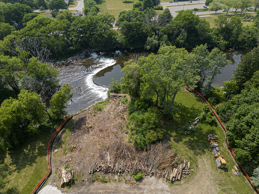 The dam at Kletzsch Park has been among the few remaining impediments to sturgeon migration on the Milwaukee River, but that will soon end when the new fish passage, under construction in this aerial view, is completed later this year. Glendale.