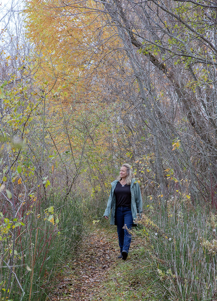 Andrea Cole walking in the preserve in autumn.