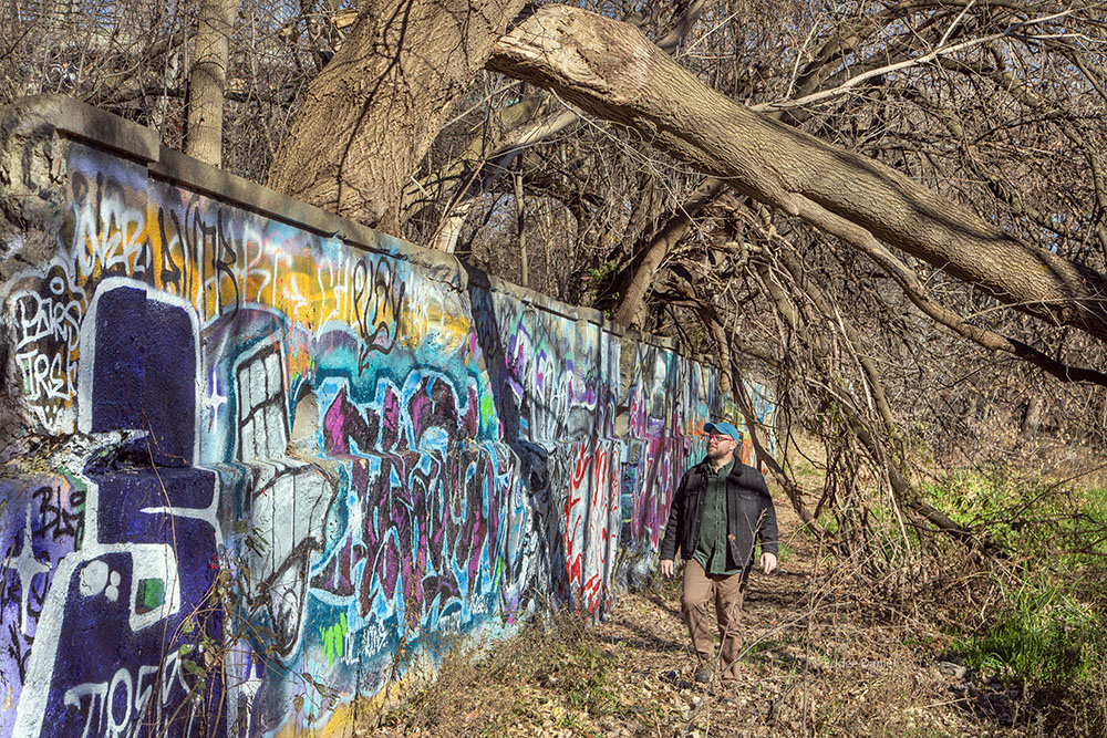 Brian Hibbard examining the ruins of the Gordon Park Bathhouse, one of the places where people went swimming before the river became too polluted.