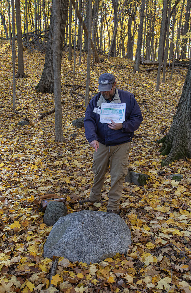 Howard Aprill pointing out a glacial erratic boulder.