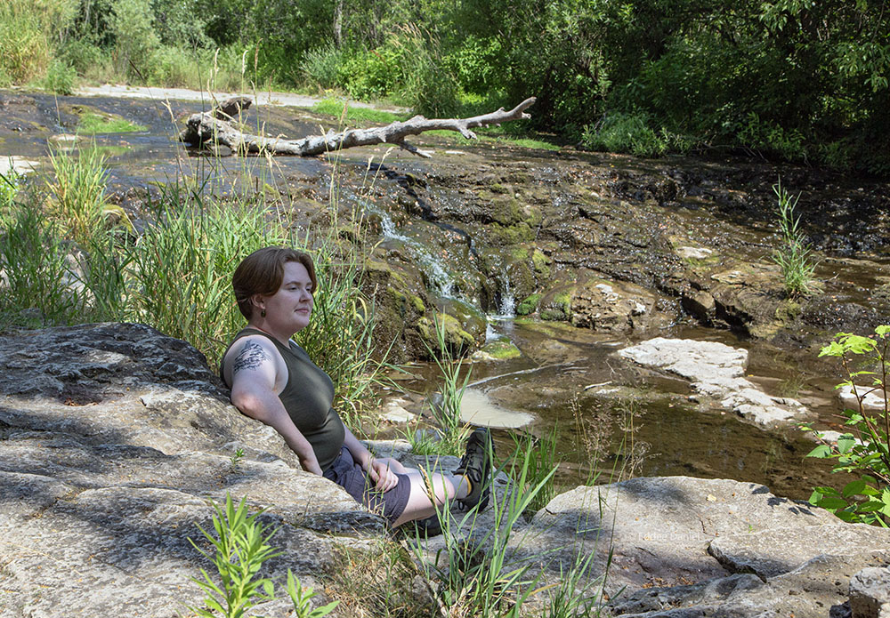 Alecia McBride at the waterfall in Sauk Creek Nature Preserve.